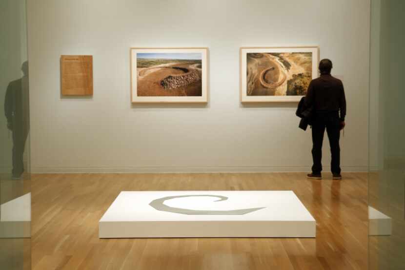 A patron views Robert Smithson's photograph of "The Amarillo Ramp" at the Dallas Museum of...