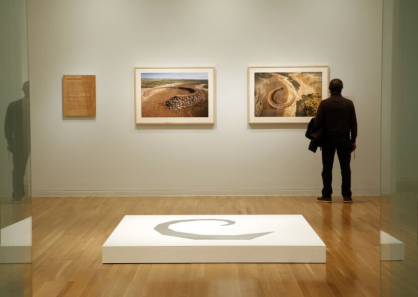A patron views Robert Smithson's photograph of "The Amarillo Ramp" at the Dallas Museum of...