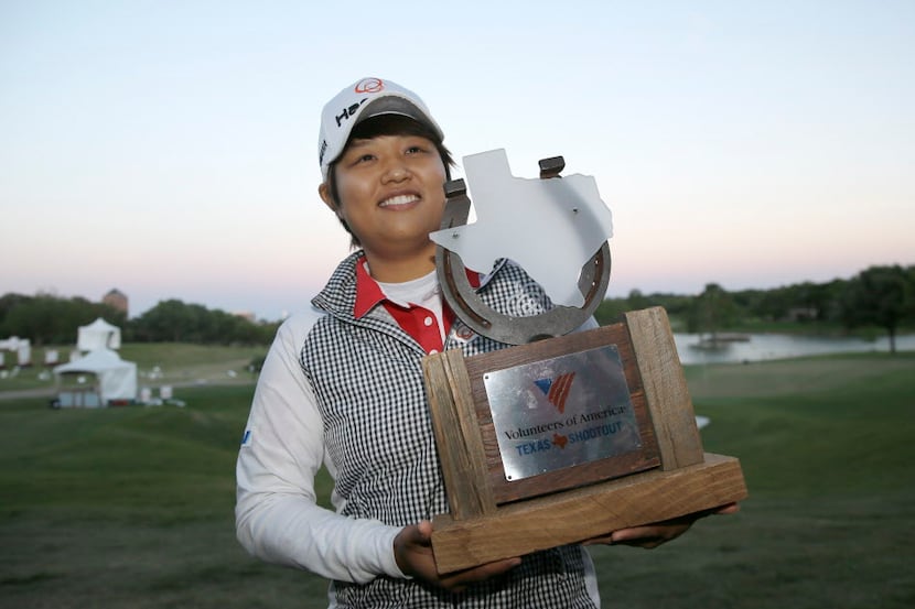 Haru Nomura, of Japan, posses with the trophy after winning sixth playoff holes against...