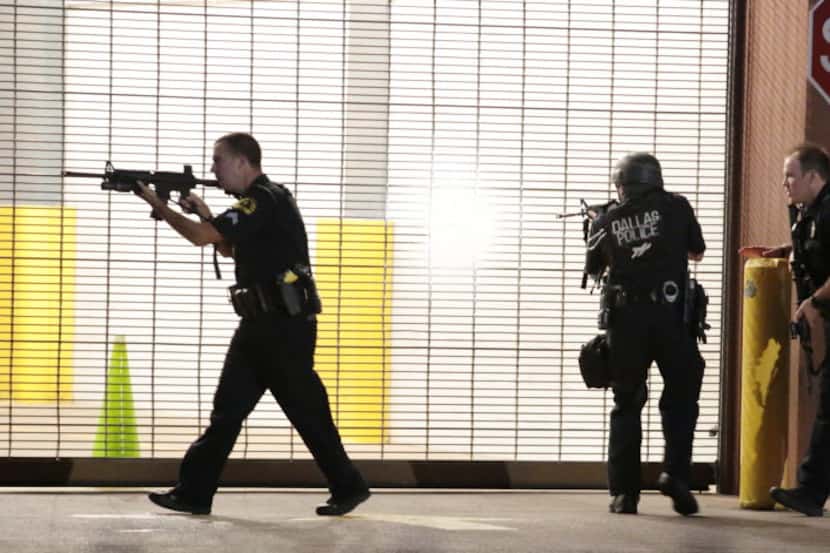 Dallas police respond after shots were fired during a protest over recent fatal shootings by...
