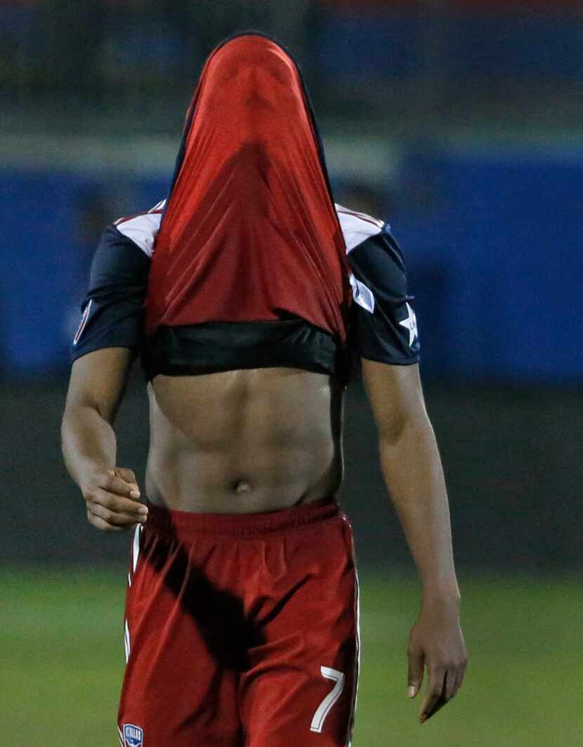 FC Dallas midfielder Carlos Gruezo (7) leaves the pitch with his shirt over his face after...