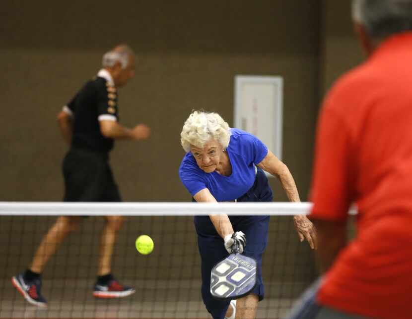 Inna Guttormson, 88, the oldest member of her pickleball club, keeps her eye on the ball as...