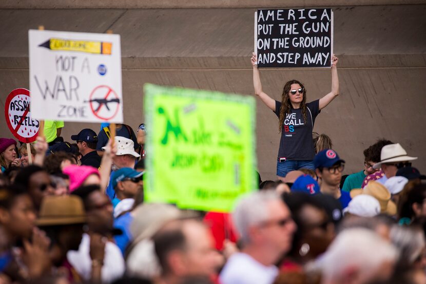 Demonstrators listen to speakers during a rally in front of City Hall.