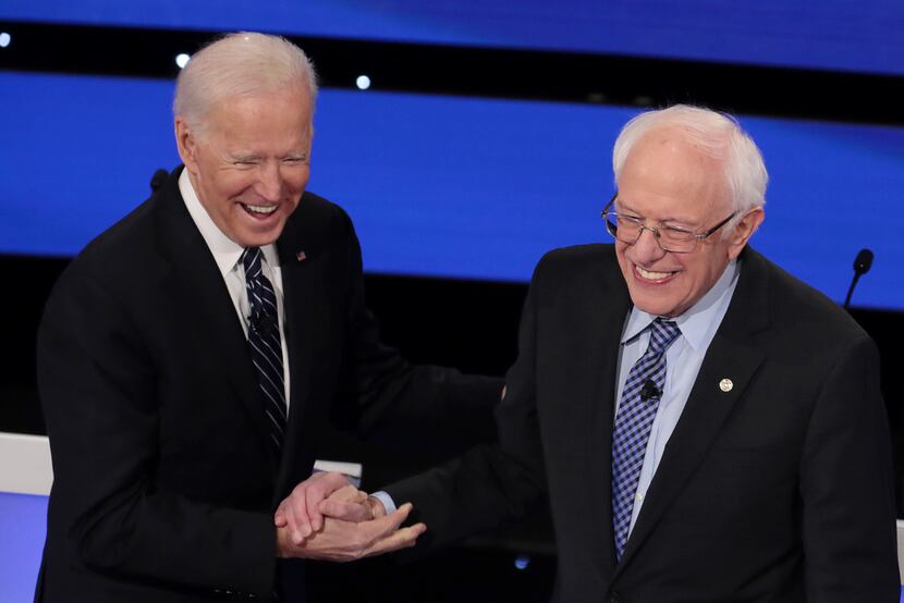 Former Vice President Joe Biden greets Sen. Bernie Sanders before the Democratic...