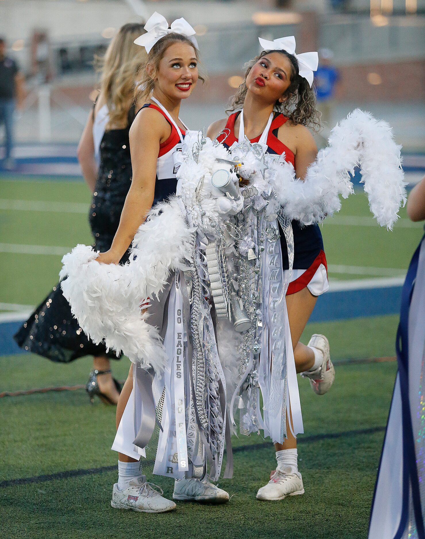 Allen High School cheerleaders Vivian Falkenstien (lefft), 18, and Thalia Wilford, 18, pose...