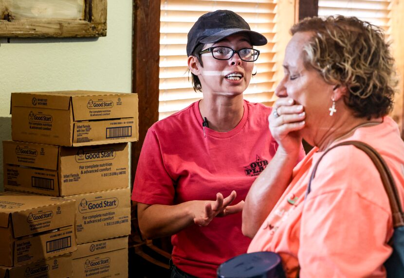 Our Place Restaurant manager Jessy Kennedy watches as Jeannie Davis reacts to receiving baby...