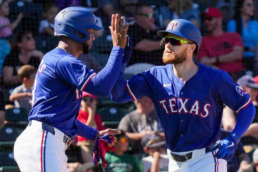 Texas Rangers infielder Jared Walsh (right) celebrates with outfielder Leody Taveras after...