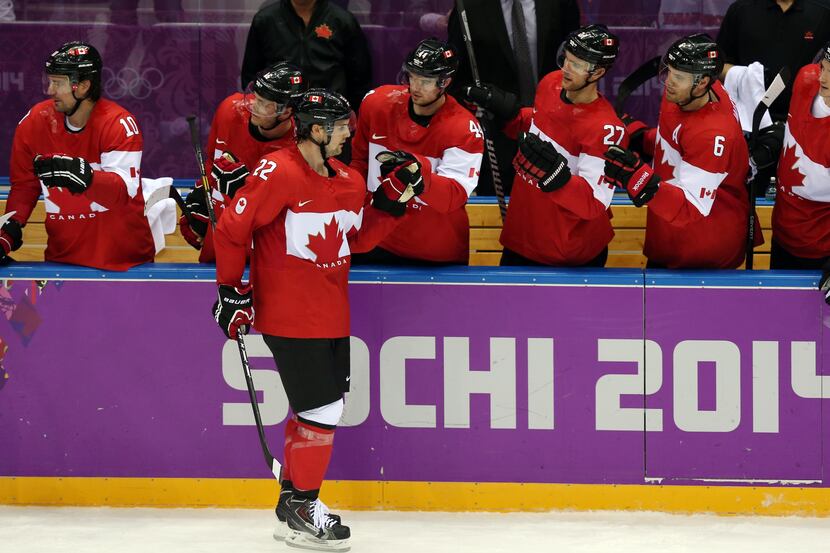 Canada forward Jamie Benn (22) is congratulated by teammates after scoring a goal against...