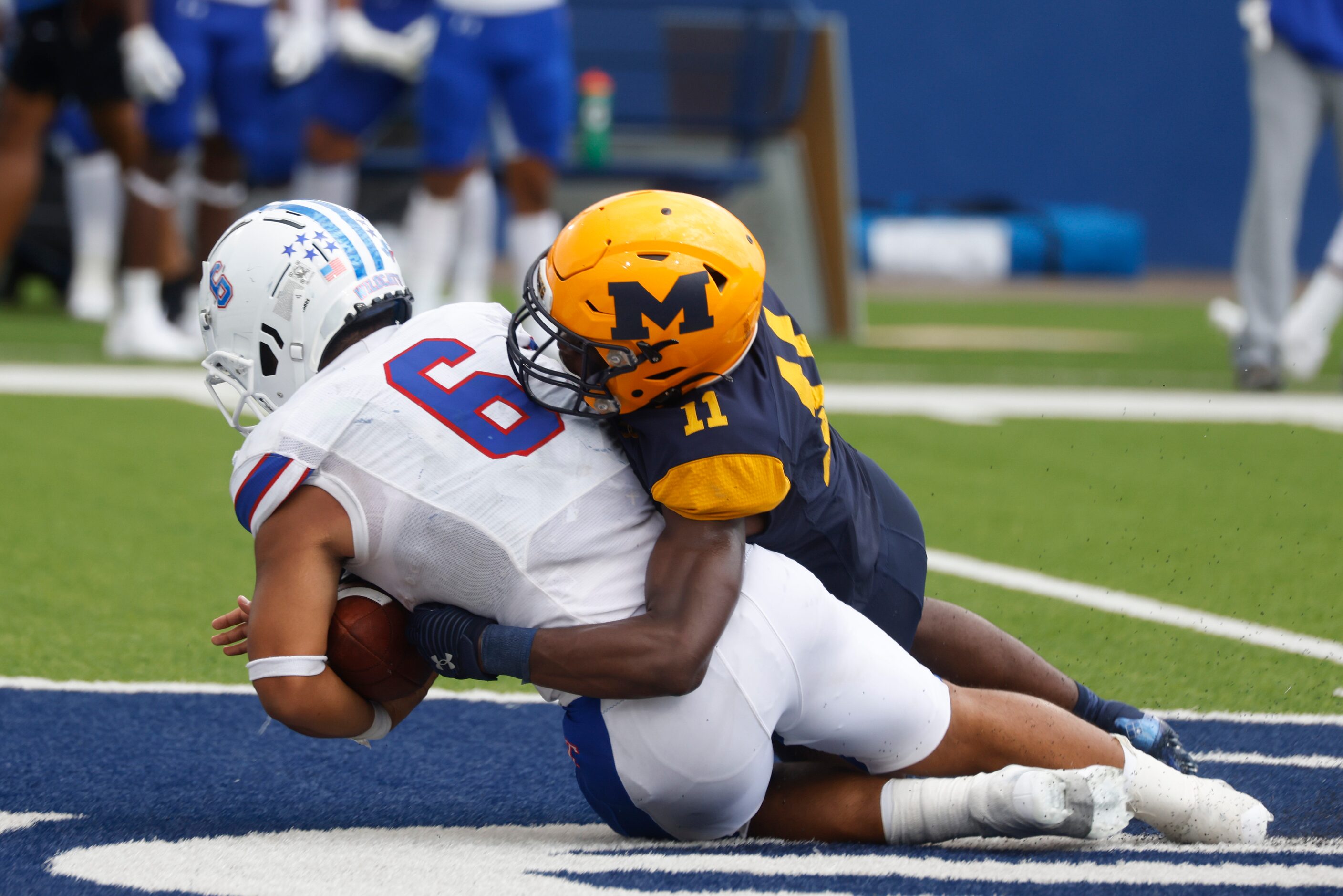 Temple High’s Deshaun Brundage (6), left, gets tackled by  McKinney High’s Deondre Shepherd...