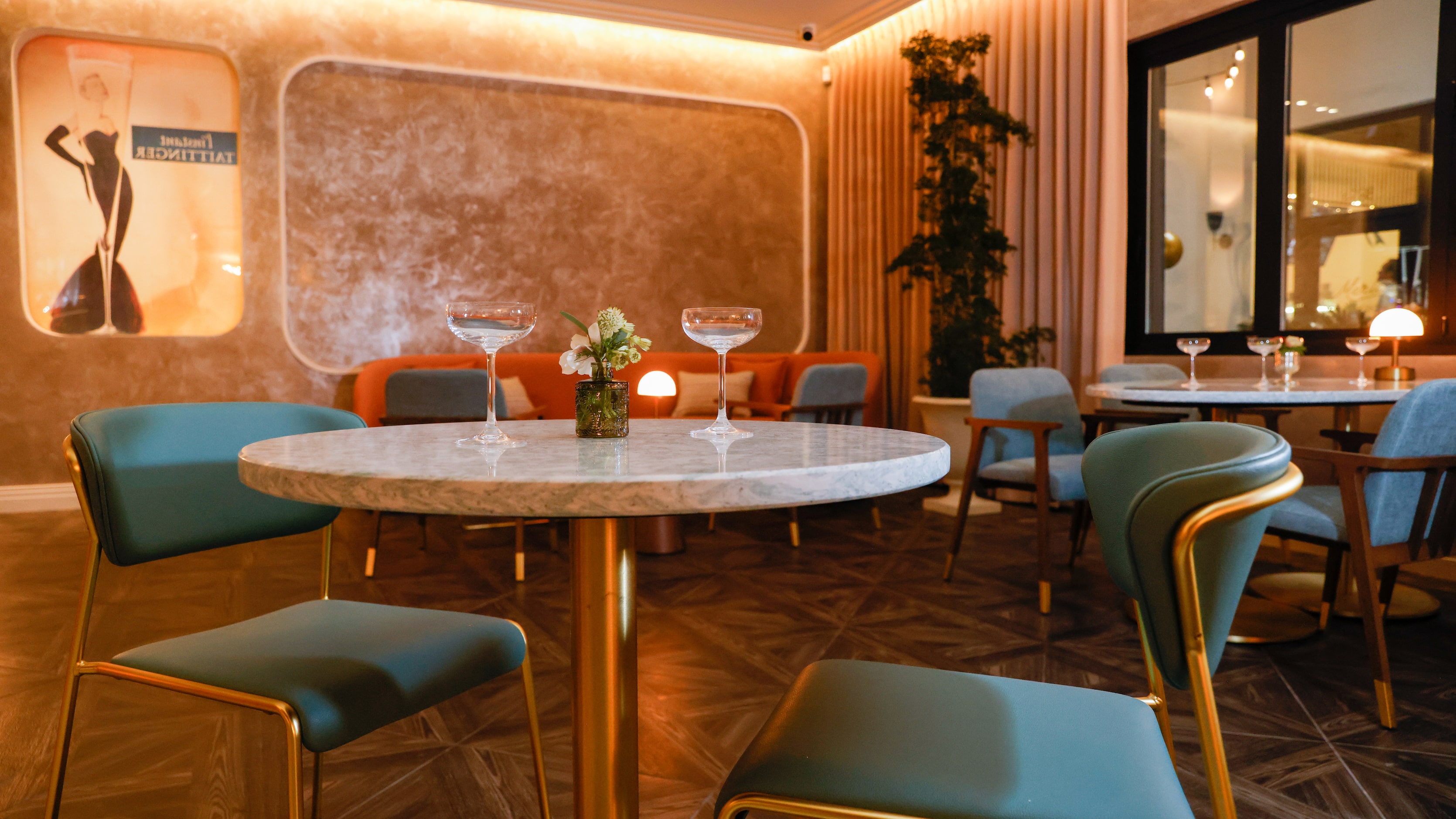 Seating options range from intimate two-top tables to couches and round booths at champagne...