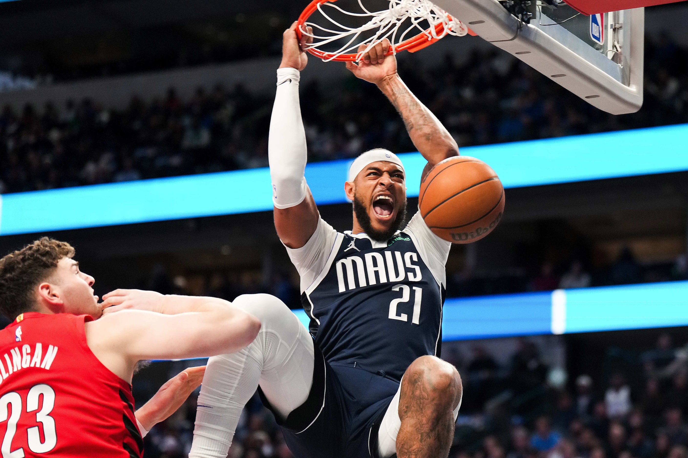 Dallas Mavericks center Daniel Gafford (21) dunks the ball past Portland Trail Blazers...