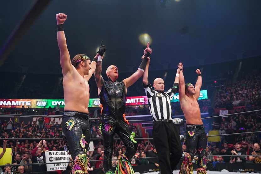 Dustin Rhodes celebrates with The Young Bucks after a victory on AEW Dynamite in Champaign,...
