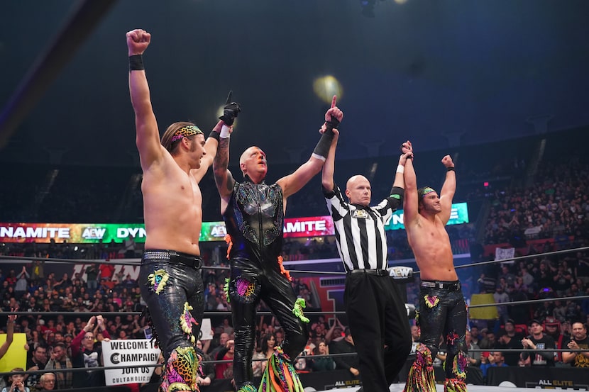 Dustin Rhodes celebrates with The Young Bucks after a victory on AEW Dynamite in Champaign,...