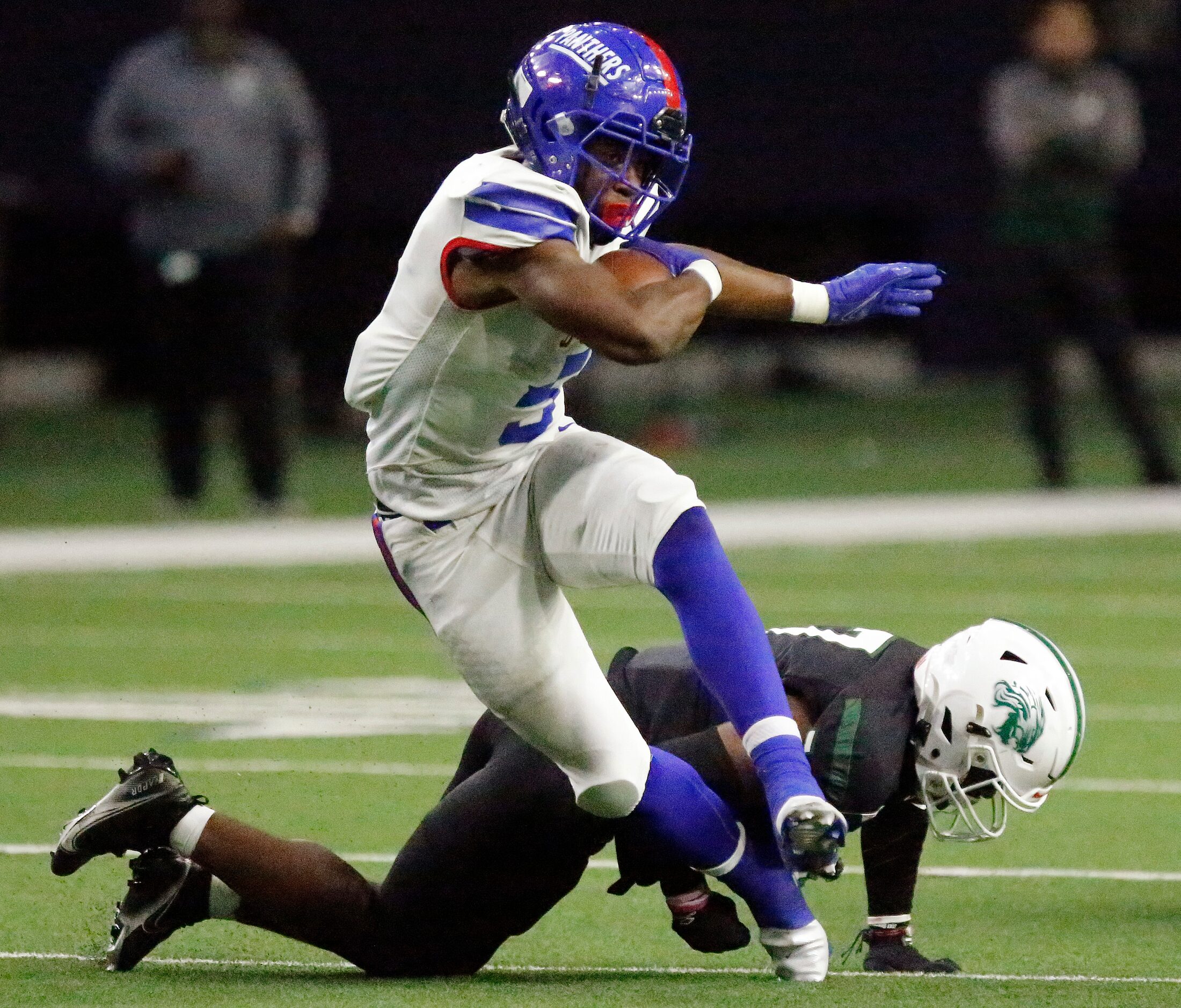 Duncanville High School running back Malachi Medlock (5) is hit by Spring High School...