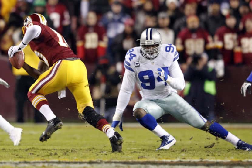 Washington Redskins quarterback Robert Griffin III (10) freezes Dallas Cowboys outside...