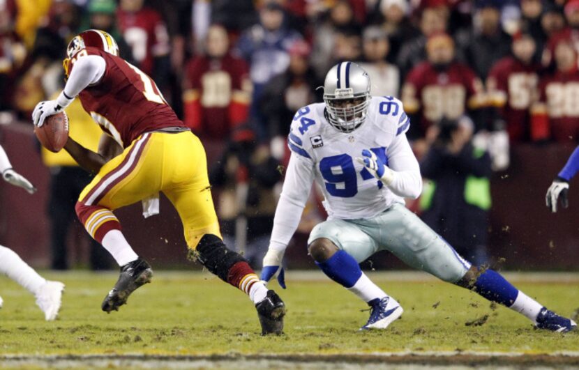 Washington Redskins quarterback Robert Griffin III (10) freezes Dallas Cowboys outside...