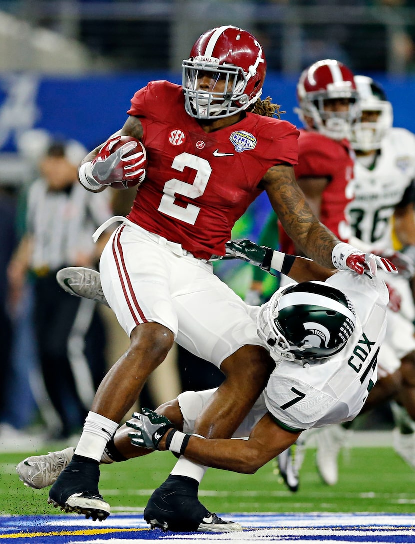 Alabama Crimson Tide running back Derrick Henry (2) pushes aside a tackle attempt by...