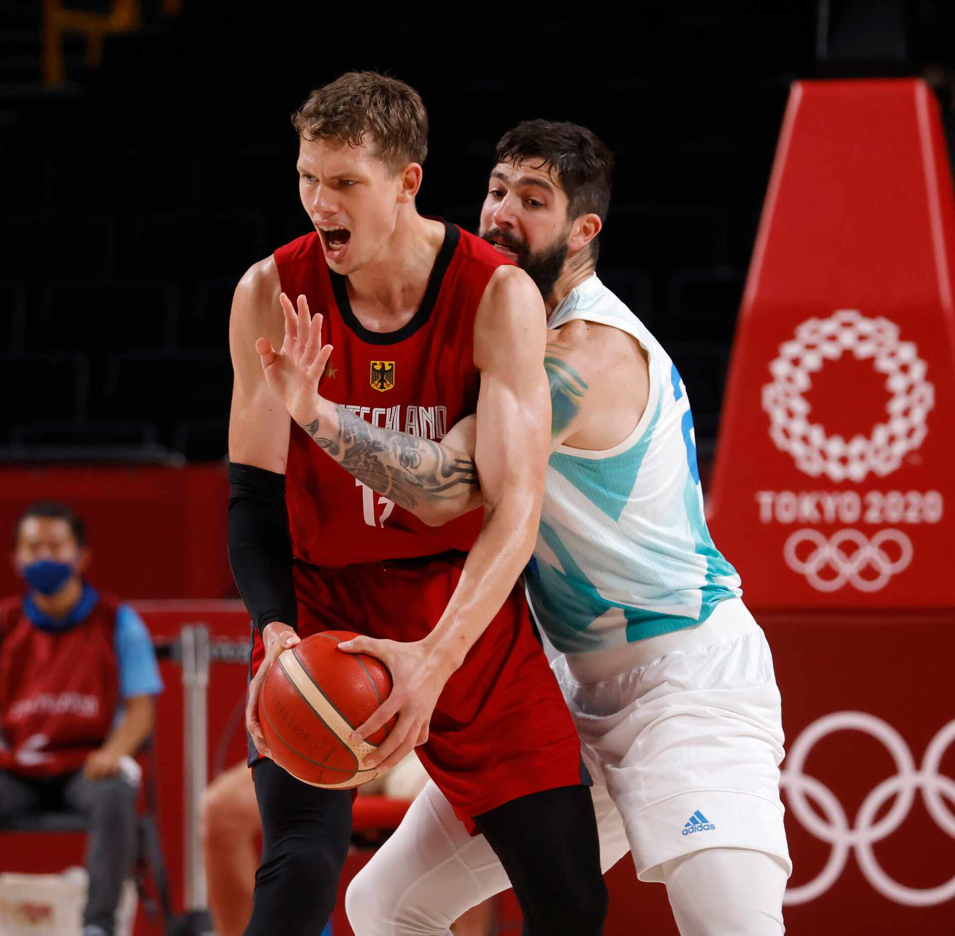 Slovenia’s Ziga Dice (27) defends as Germany’s Moritz Wagner (13) looks to pass during the...