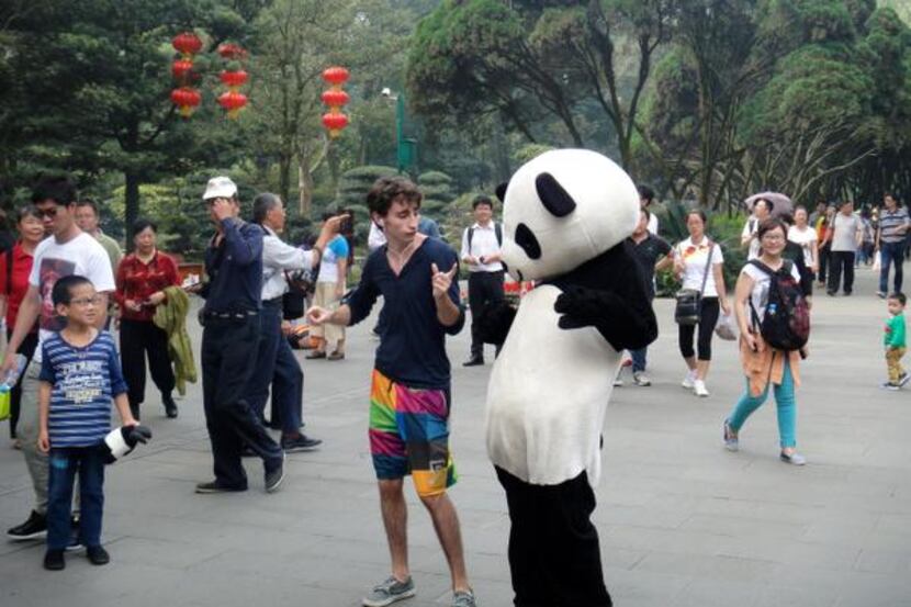 
Lake Highlands High School graduate Jake Gaba dances with a man in a panda suit in Chengdu,...