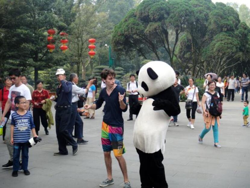
Lake Highlands High School graduate Jake Gaba dances with a man in a panda suit in Chengdu,...