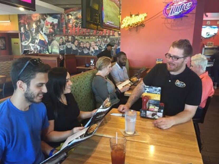 Kasey Simmons, waiting a table at Applebee's in Little Elm. The 32-year-old waiter's kind...