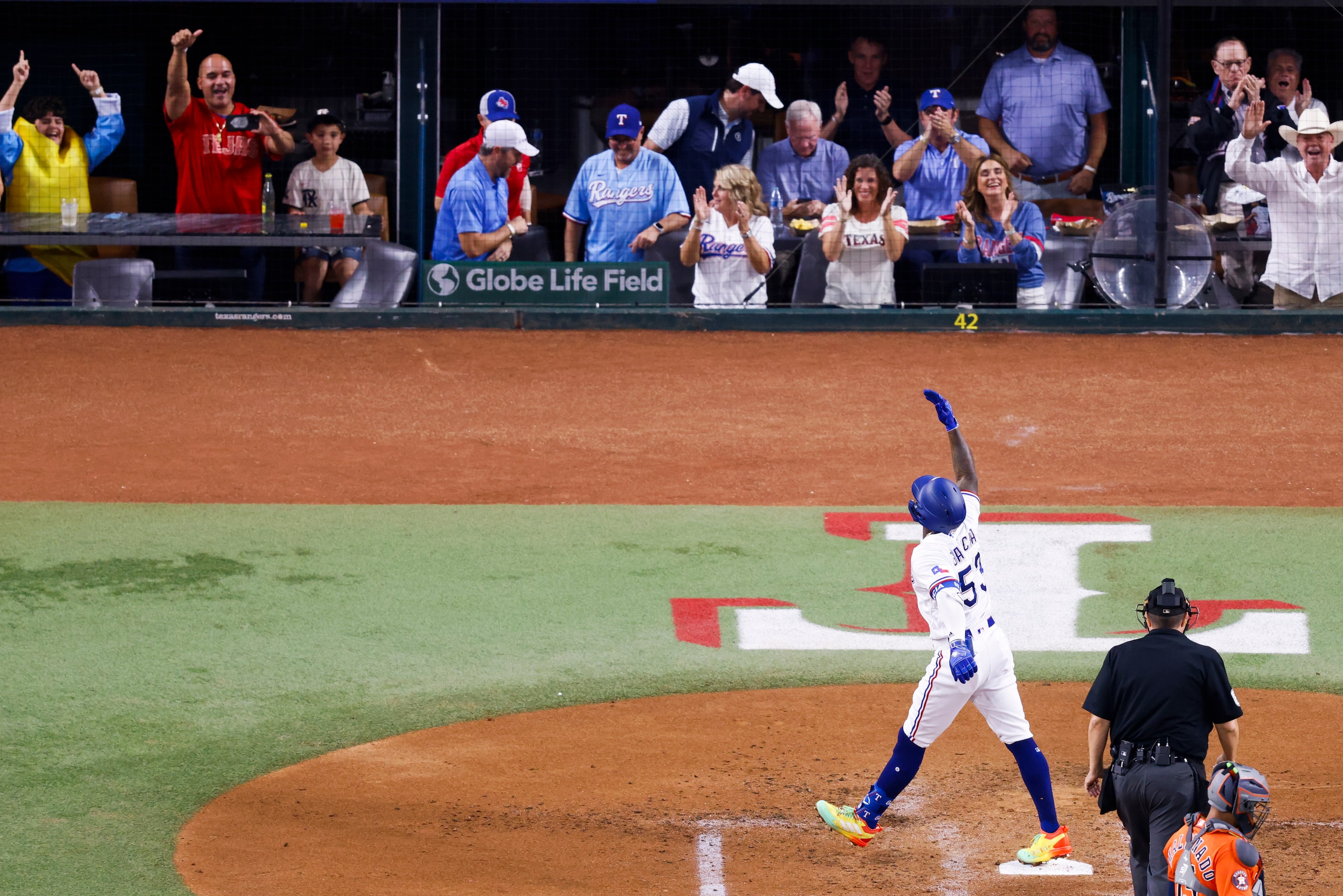 Texas Rangers right fielder Adolis Garcia (53) celebrates at home plate after hitting a home...