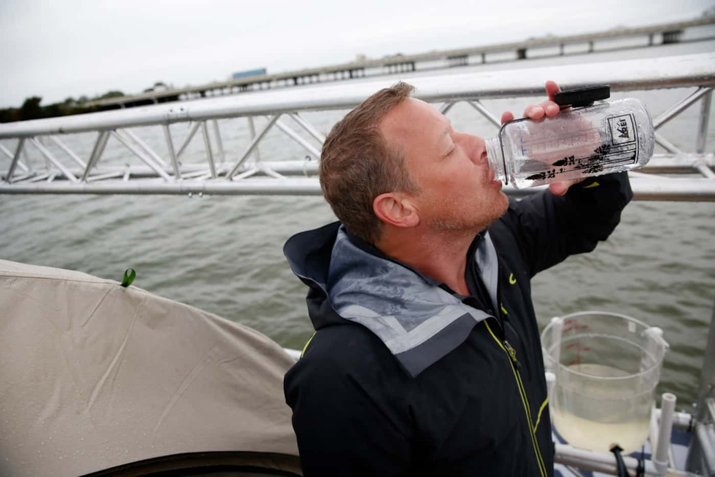 Todd Phillips, founder and director of the Last Well, drinks filtered water on his wooden...