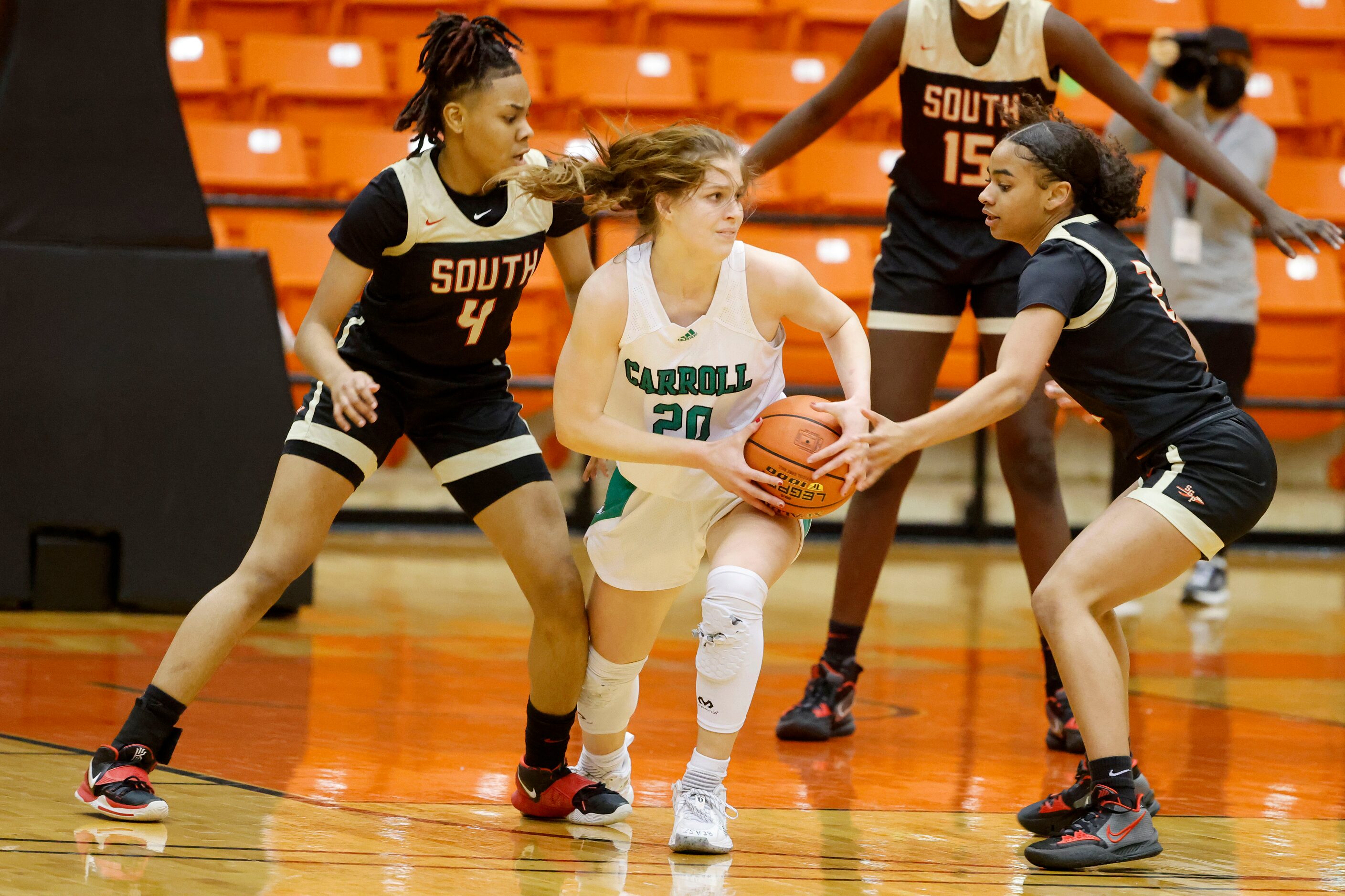 South Grand Prairie players Joy Madison-Key (4) and Ahrianna Morgan (2) defend against...