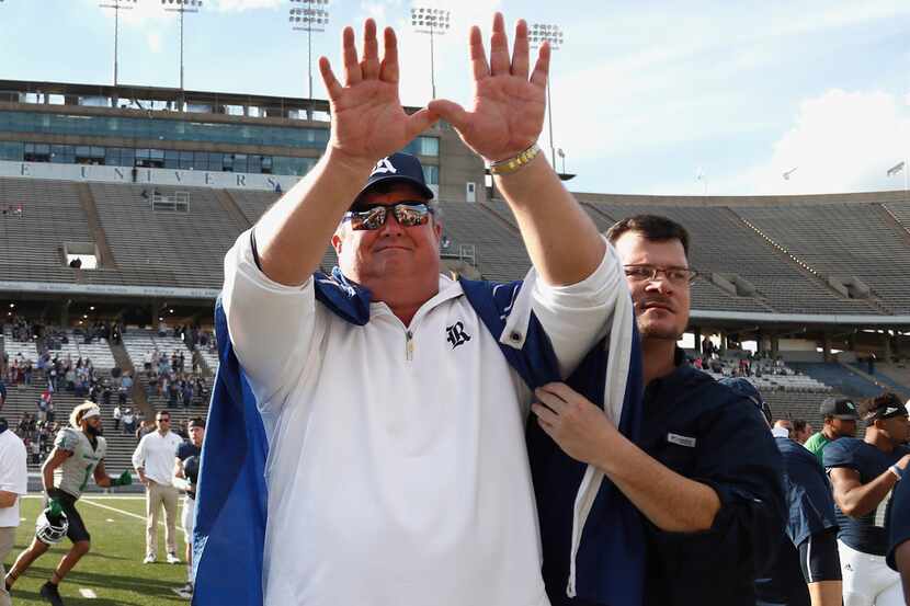 Rice head coach David Bailiff puts his hands up in the air for the Rice school song, as a...