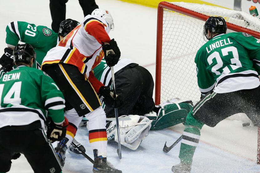 Calgary Flames center Sean Monahan (23) gets the puck into the goal for a score against...