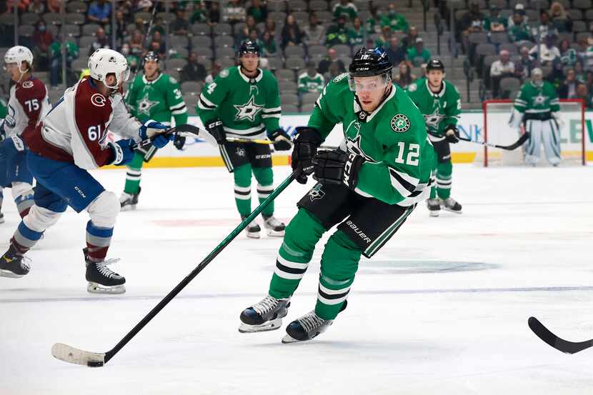 Dallas Stars center Radek Faksa (12) brings the puck up ice against the Colorado Avalanche...