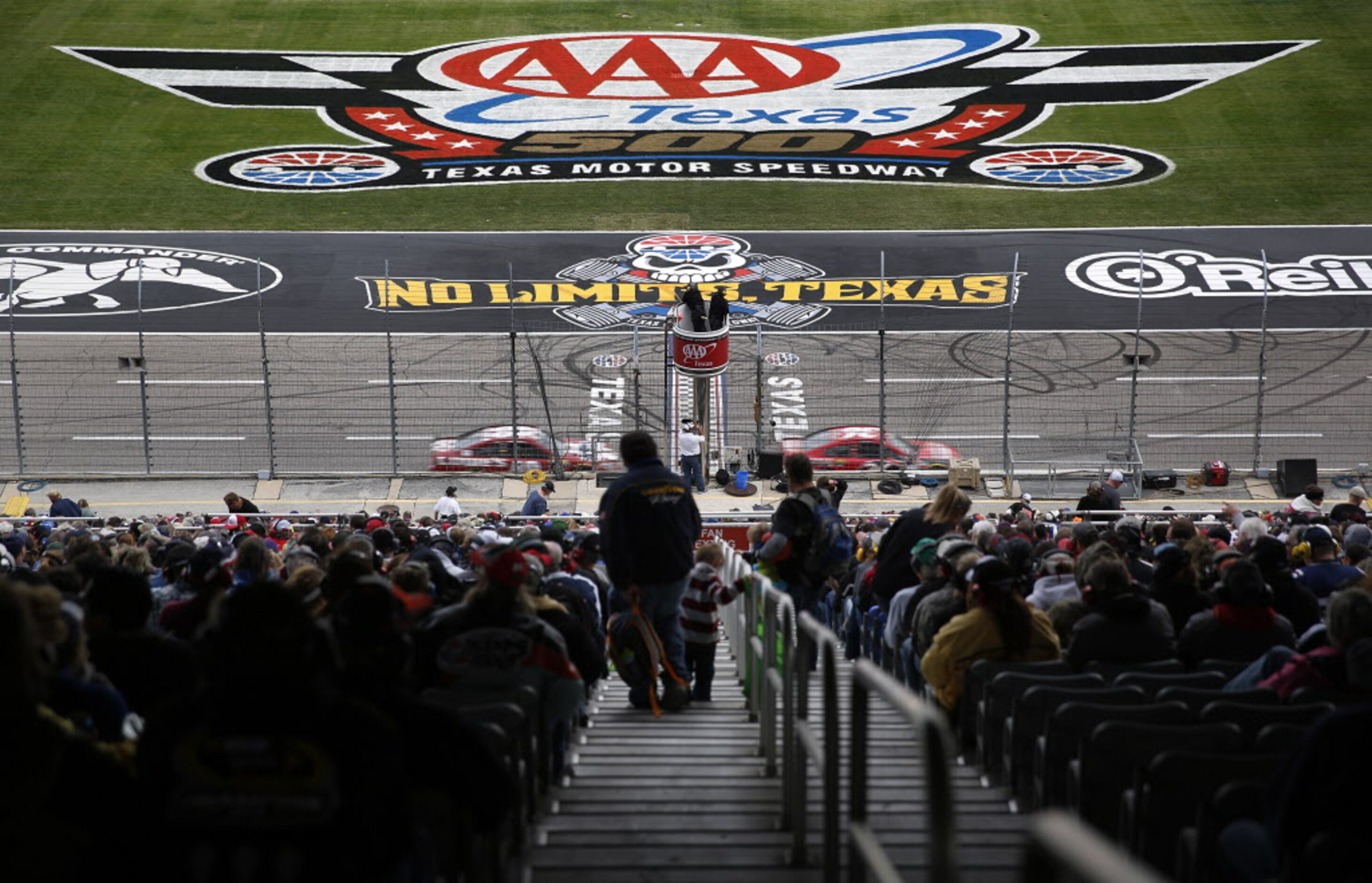 Fans file into their seats during the AAA Texas 500 at the Texas Motor Speedway in Fort...