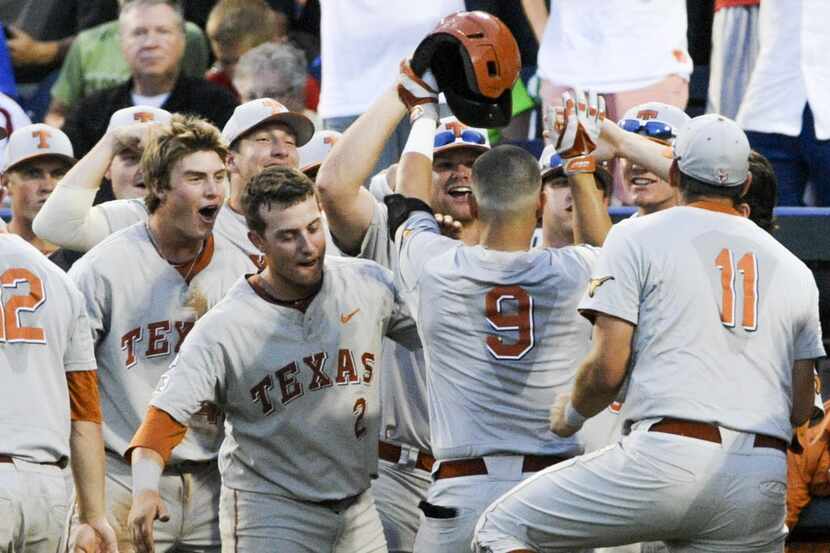 Texas players greet C.J Hinojosa (9) to the dugout after he hit a home run against UC Irvine...