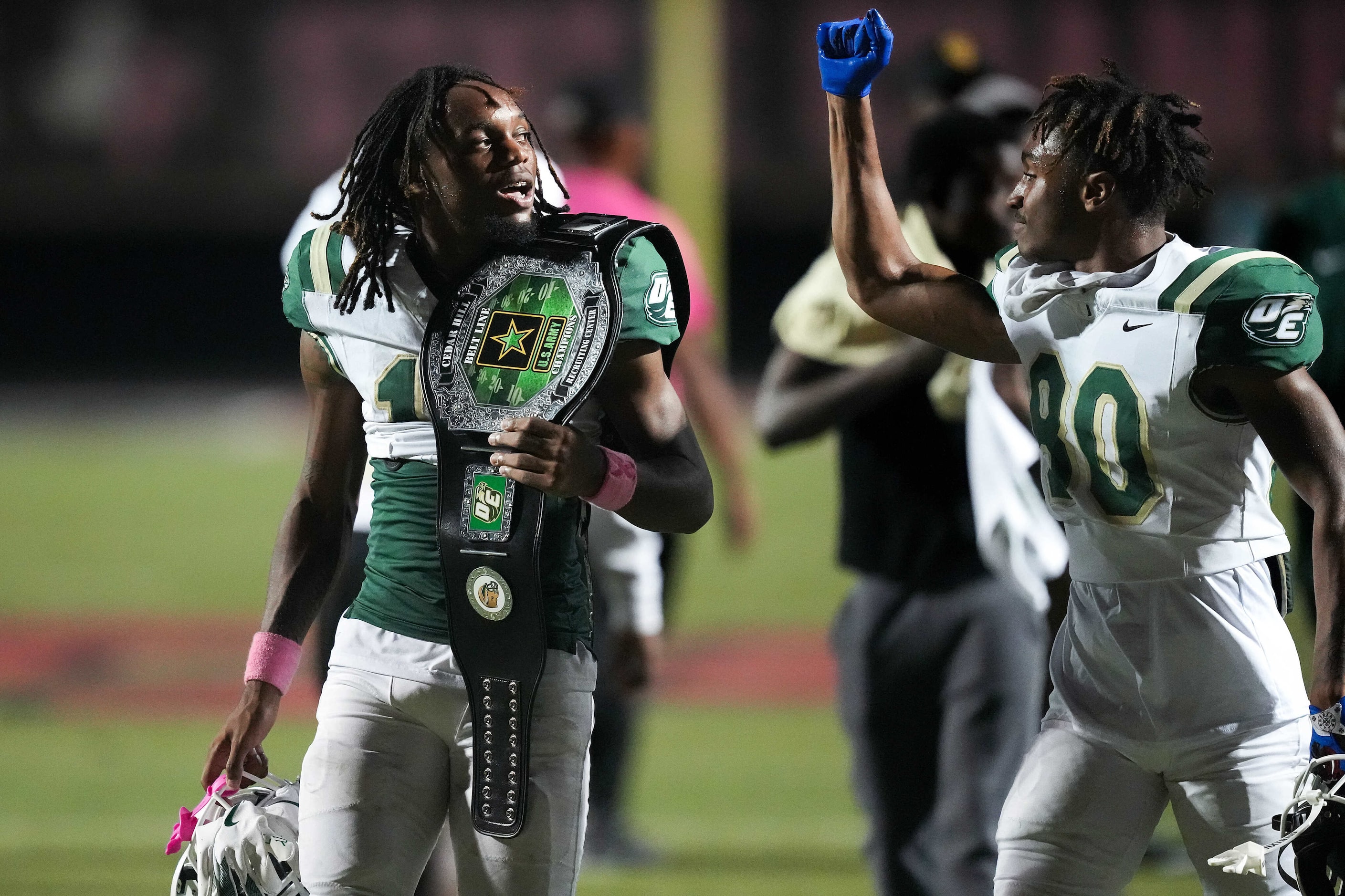 DeSoto wide receiver Daylon Singleton (13) celebrates with Jordan Marshall-Kelly (80)  after...