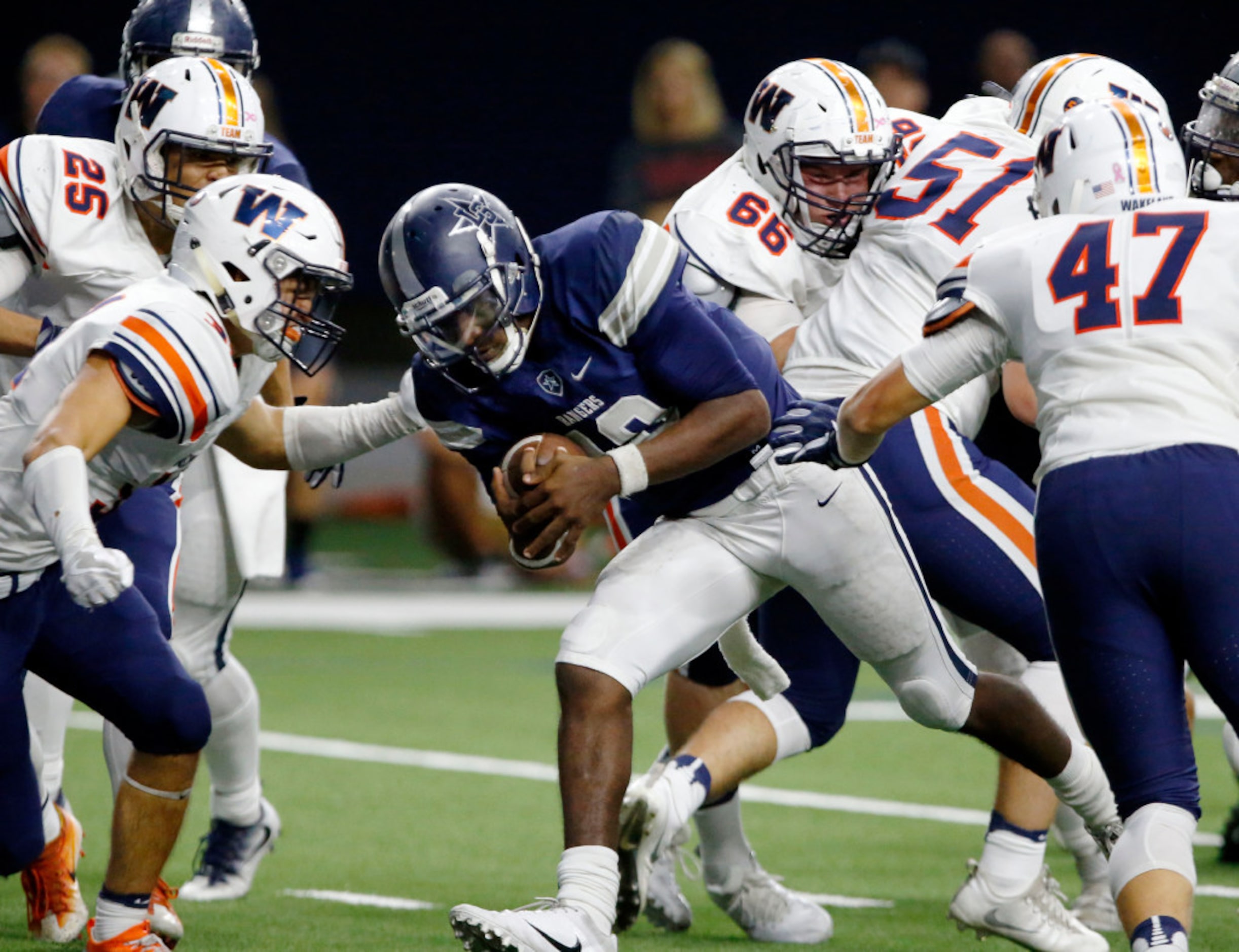 Frisco Lone Star High QB Jason Shelley (18) punches through the Frisco Wakeland High defense...