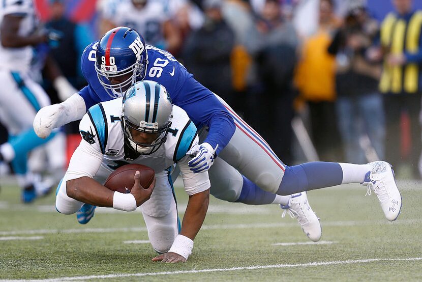 EAST RUTHERFORD, NJ - DECEMBER 20:   Jason Pierre-Paul #90 of the New York Giants sacks Cam...