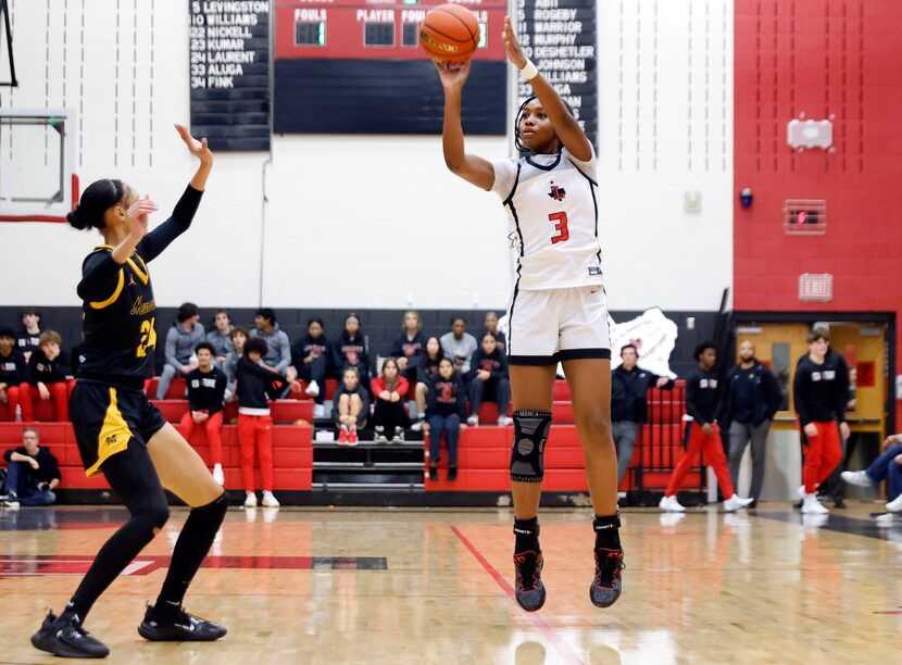 Frisco Liberty’s Jacy Abii (3) puts up a first half three-pointer against Frisco Memorial’s...