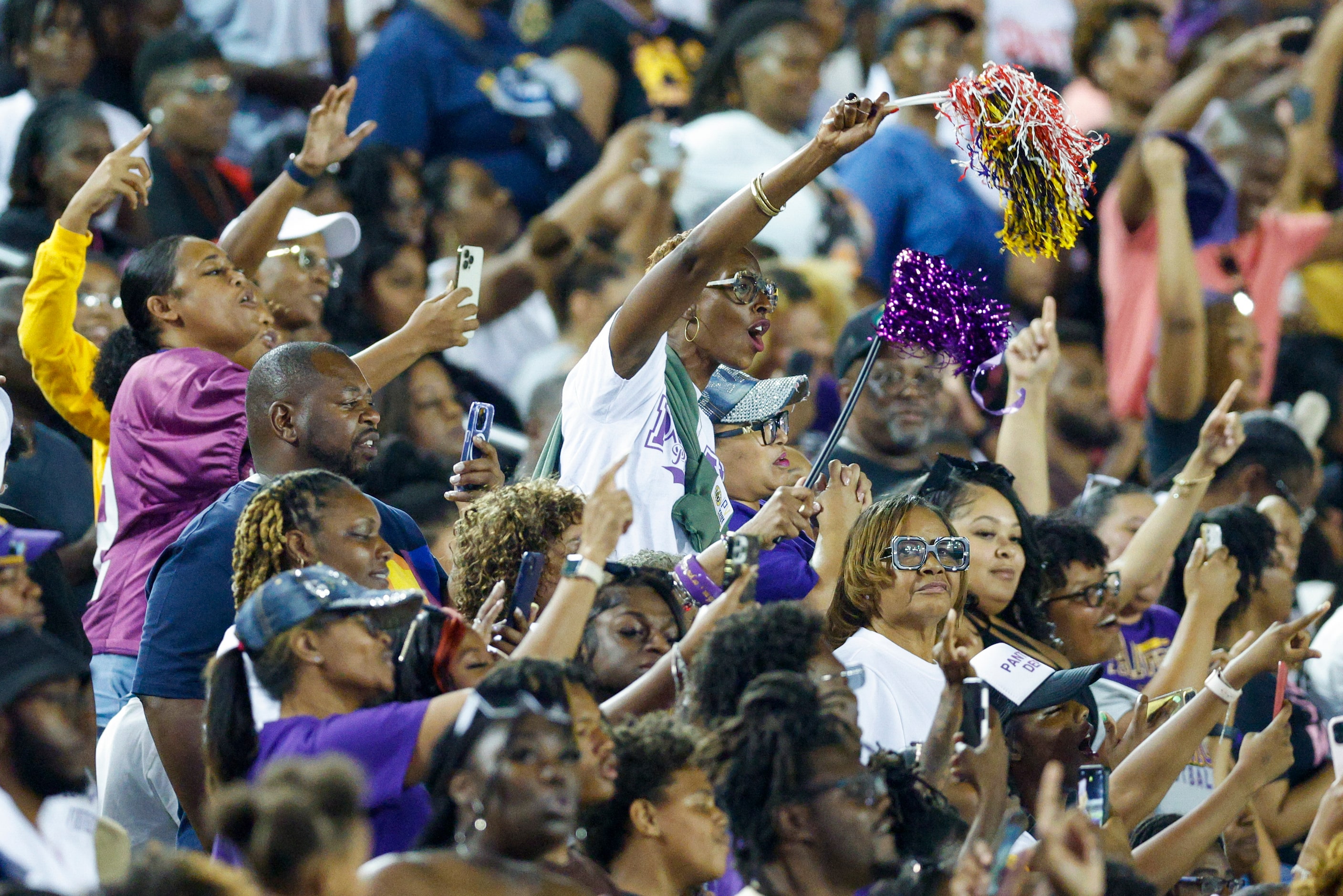 Fans cheer as the Prairie View A&M marching band performs during halftime of the State Fair...