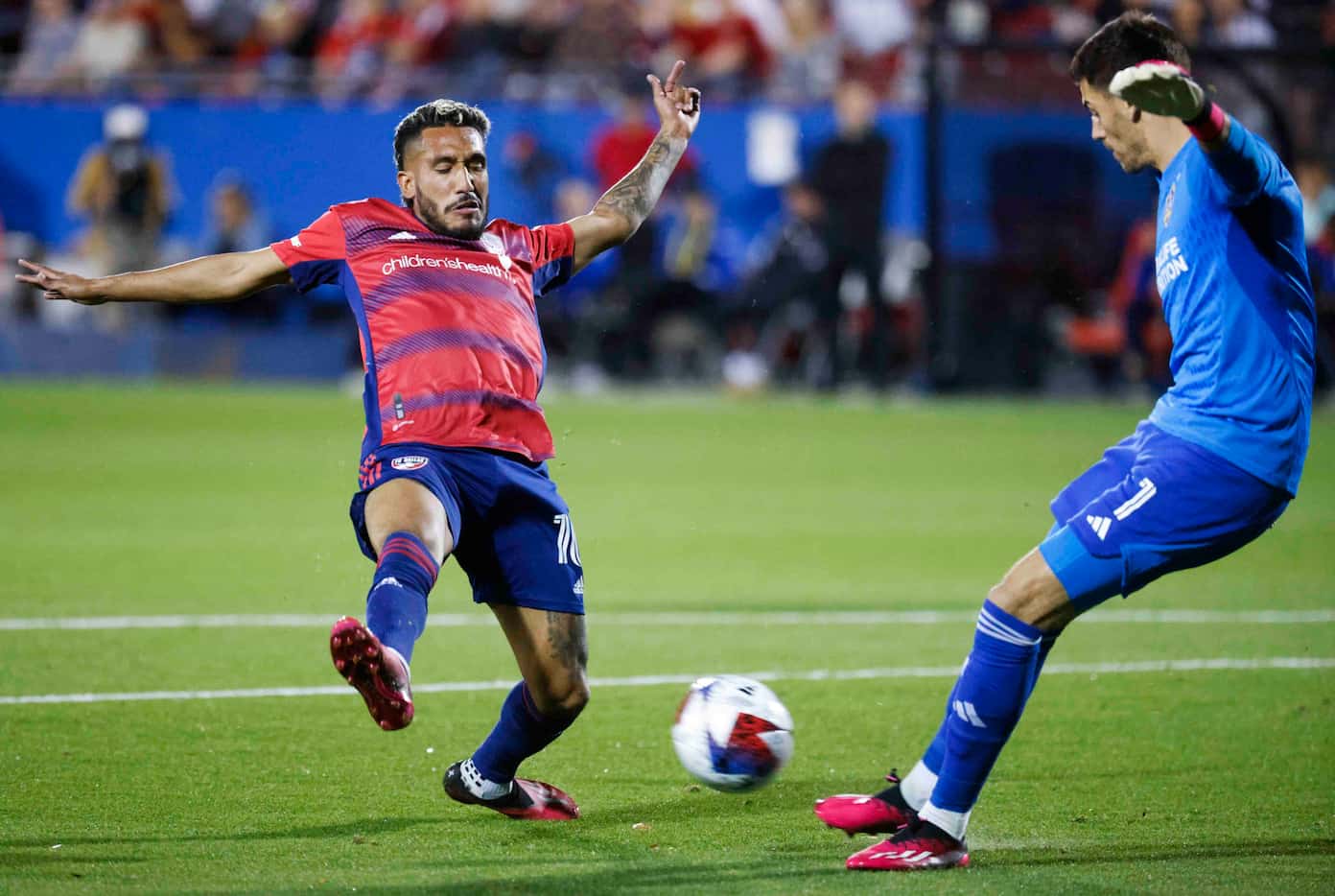 FC Dallas forward Jesús Ferreira (left) tries to block a reverse kick by Los Angeles Galaxy...