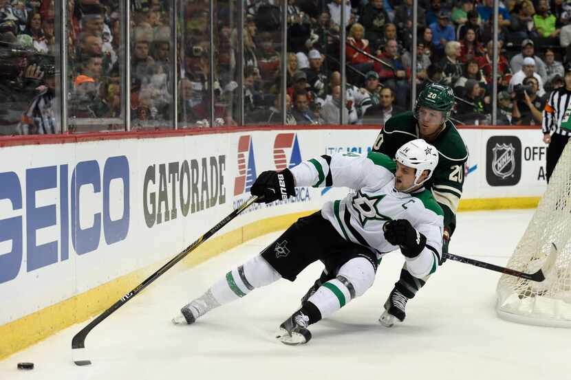 ST PAUL, MN - APRIL 18: Jamie Benn #14 of the Dallas Stars controls the puck as he falls to...