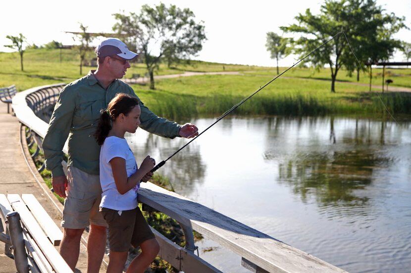 Ross Bond (left) of Coppell gave pointers to his daughter Alexandra, at Brockdale Park on...