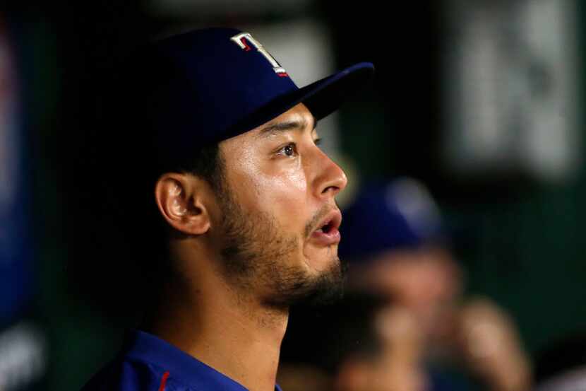 Texas Rangers starting pitcher Yu Darvish (11) sits in the dugout during the 6th inning...