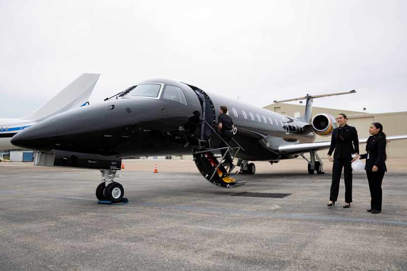 The Aero crew prepares an Embraer ERJ135 jet before a media preview flight at Dallas Love...