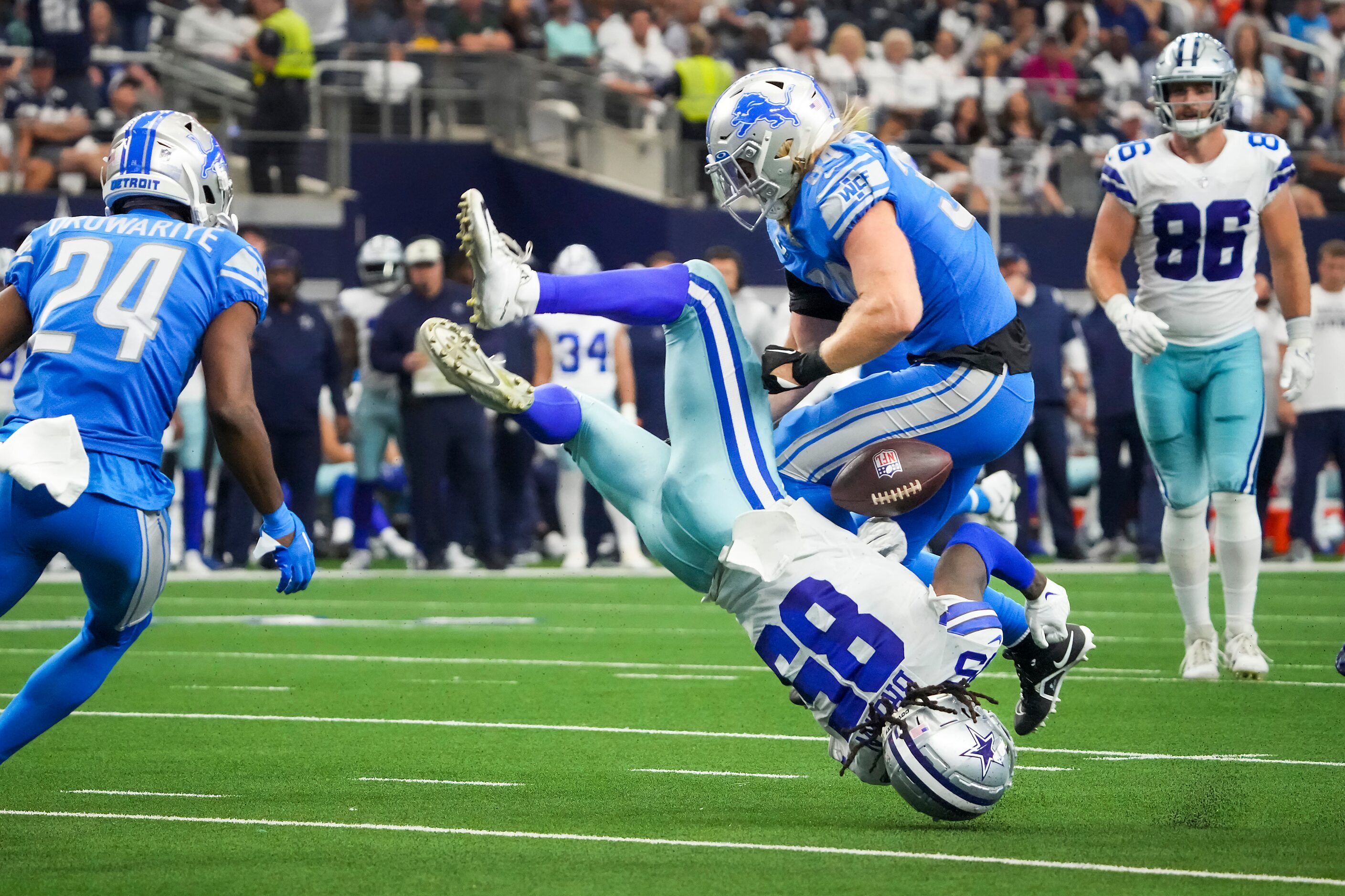 Dallas Cowboys wide receiver Noah Brown (85) fumbles as he is flipped upside down while...