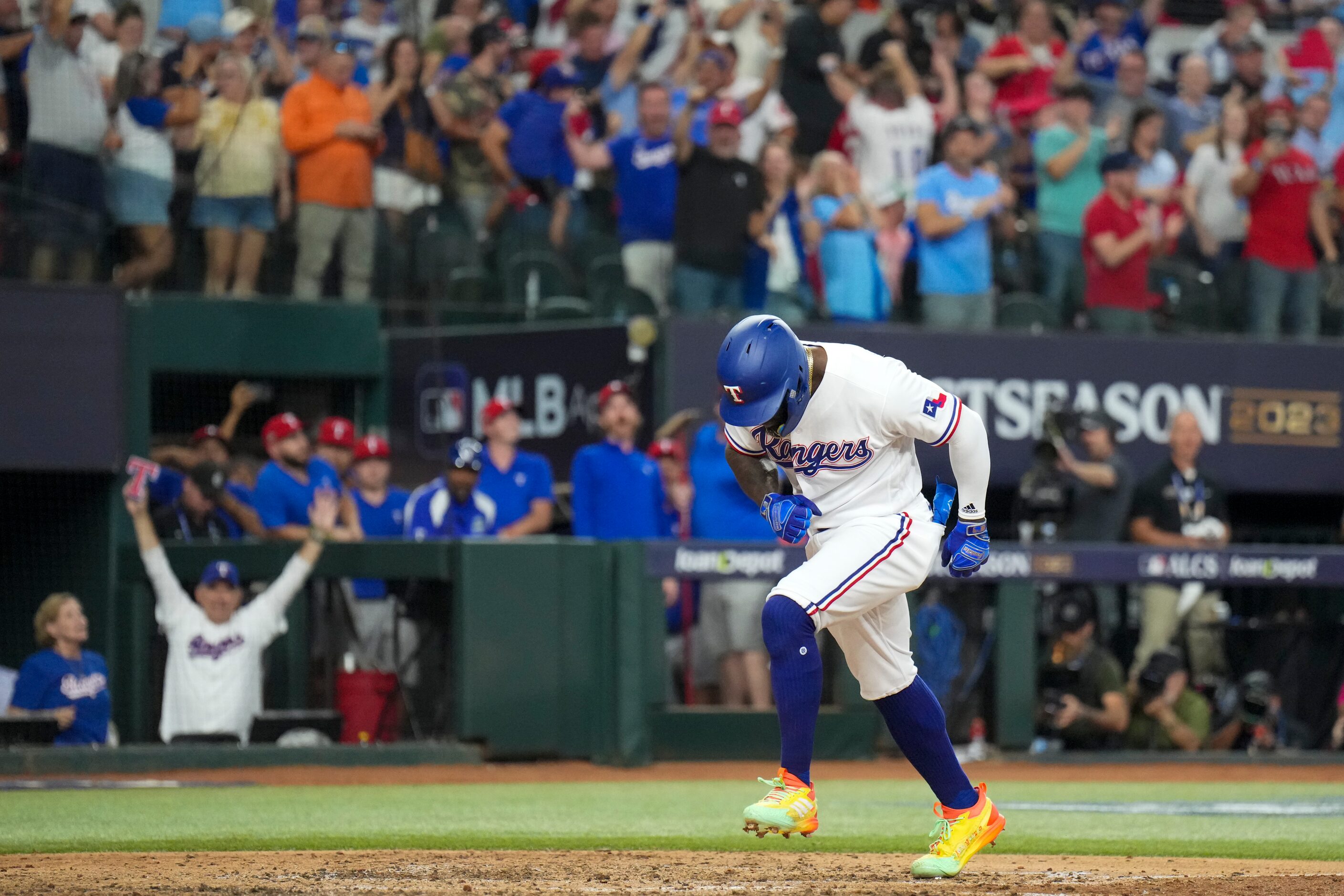 Texas Rangers right fielder Adolis Garcia celebrates as he steps on home after hitting a...