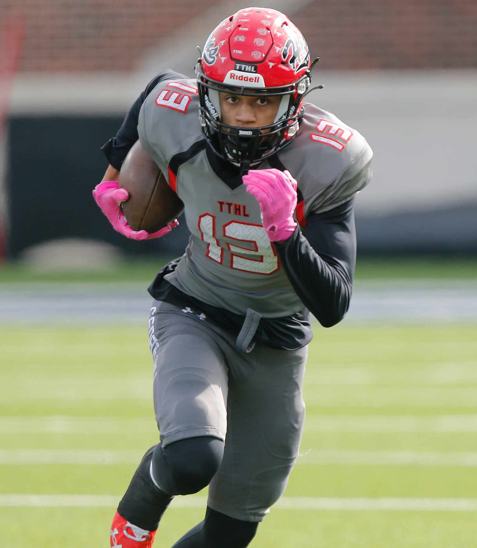 Cedar Hill High School wide receiver Javien Clemmer (13) makes a run for extra yardage after...