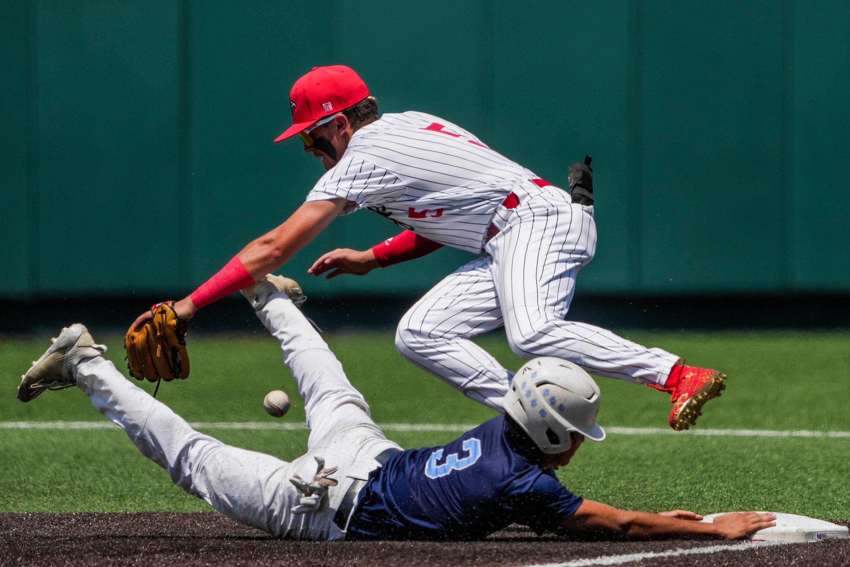 China Spring Gabe Watkins (3) slides under the tag as the ball gets past Argyle second...