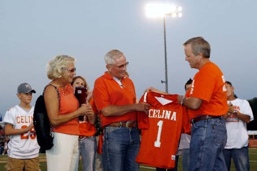  Former Celina football coach G.A. Moore, Jr. is joined by his wife Lois Ann, left, while he...