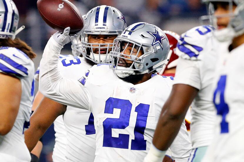 Dallas Cowboys running back Ezekiel Elliott (21) tosses the ball to the referee after a...