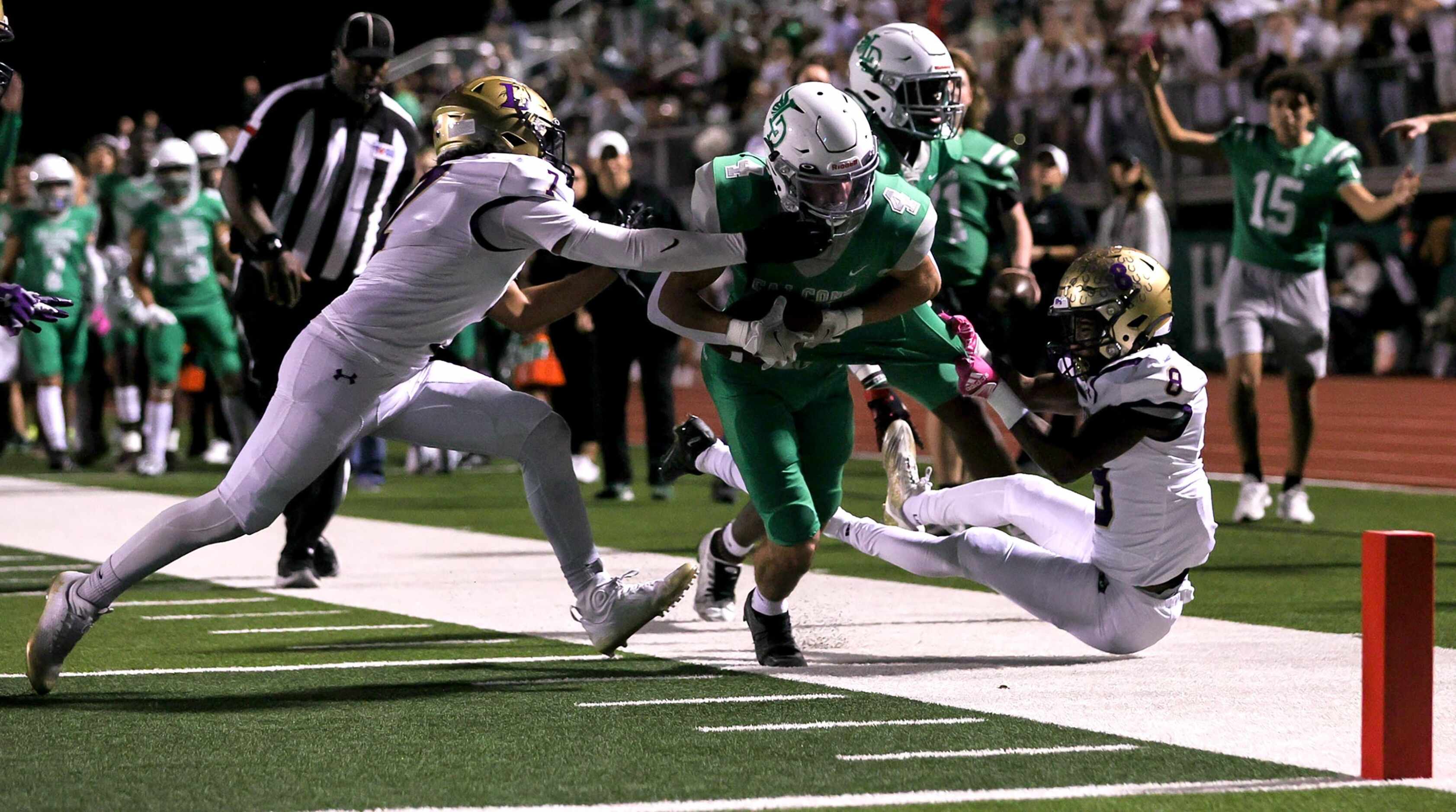 Lake Dallas running back Dylan Brauchle (4) fights his way to the goal line as he is forced...